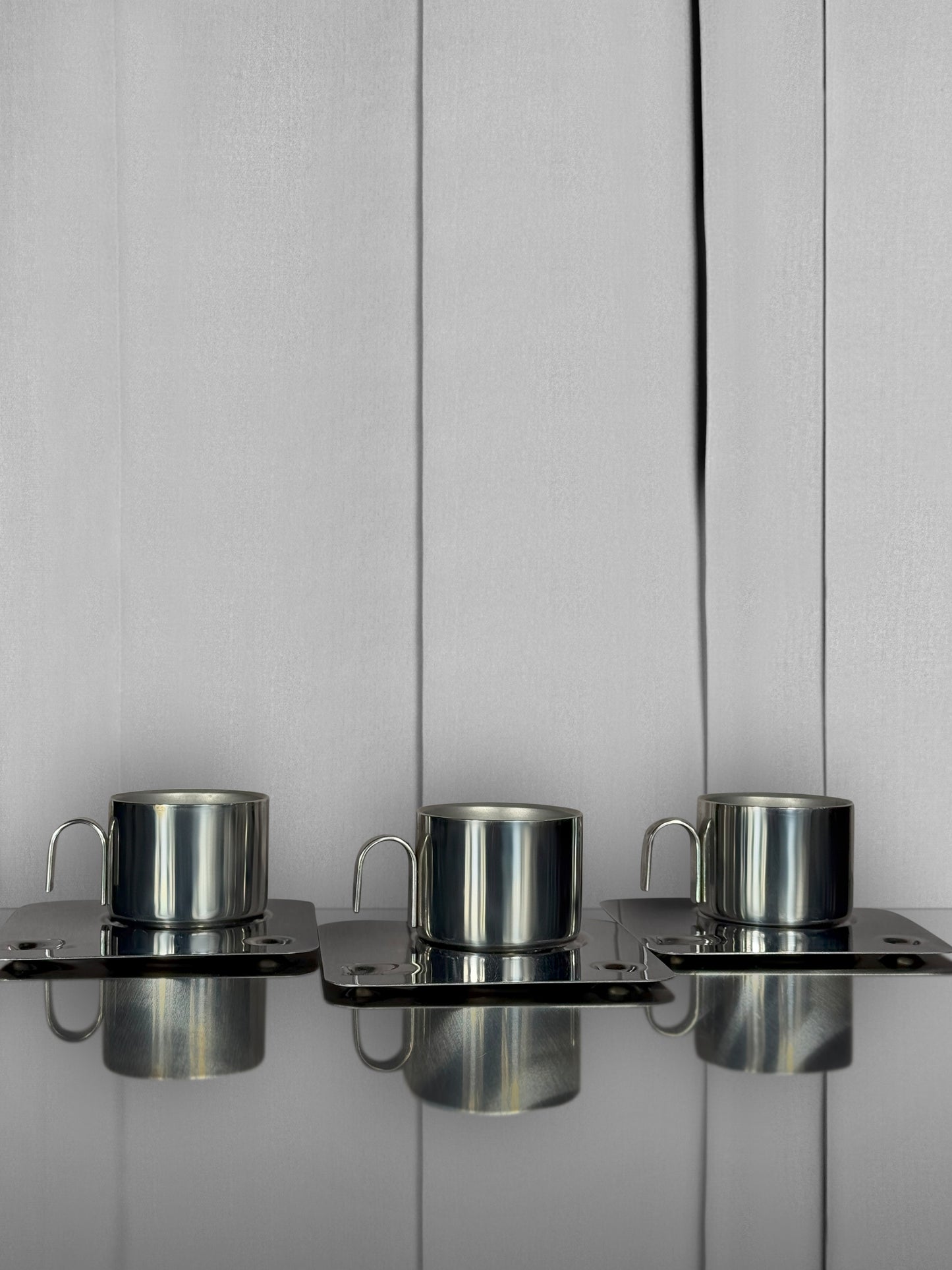 Coffee in a steel cup on a geometric tray